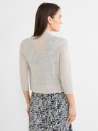 Light grey bolero cardigan with sheer knit, subtle back pattern, 3/4 ribbed sleeves, and mock neck. Waist-length.