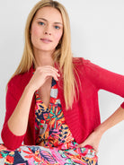 Red bolero cardigan, fine knit, 3/4 length sleeves with ribbed cuffs, cropped length. Open front.