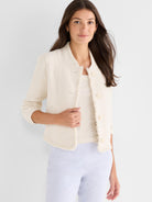 Cropped cream textured knit jacket featuring a collarless neckline, three-quarter sleeves, and frayed edge details.