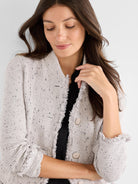 Light gray tweed cardigan jacket with fringe trim, speckle detail, and large front buttons.