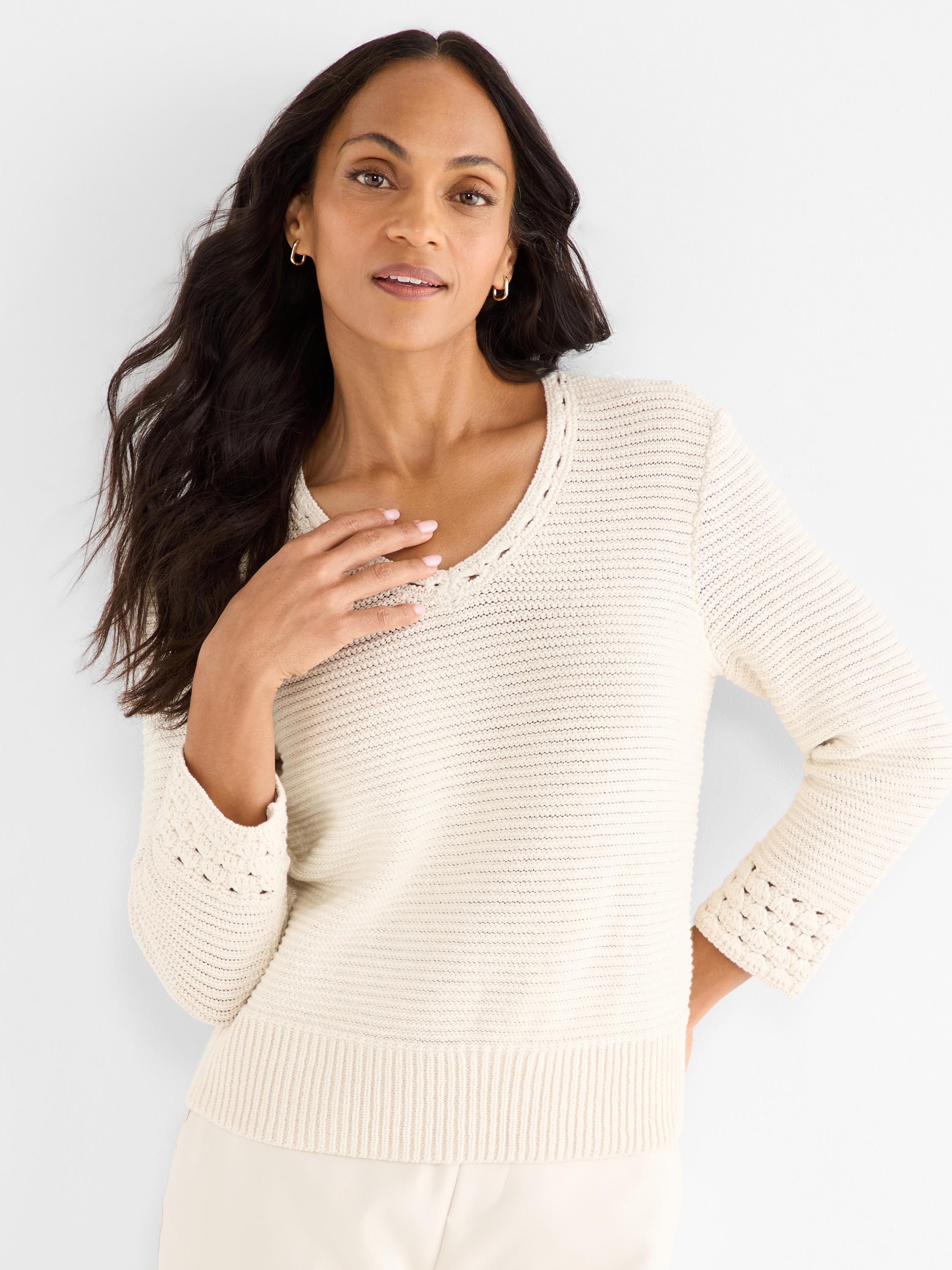 Ivory knit sweater, standard fit, featuring a detailed crocheted scoop neckline and matching cuffs.