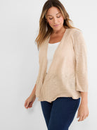 Light beige open-front cardigan featuring a relaxed fit, sheer knit texture, and three-quarter sleeves with ribbed cuffs.