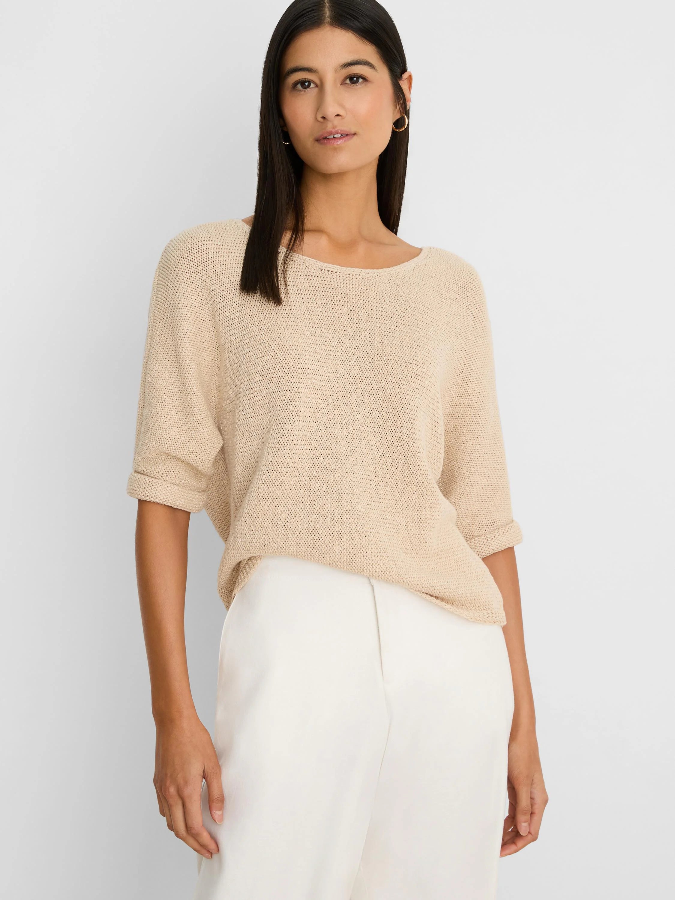 Light beige crimpy cord knit sweater with a boat neck and rolled short sleeves, worn by a model.