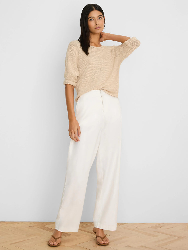 Light beige textured knit sweater with elbow-length rolled sleeves and a wide neckline.