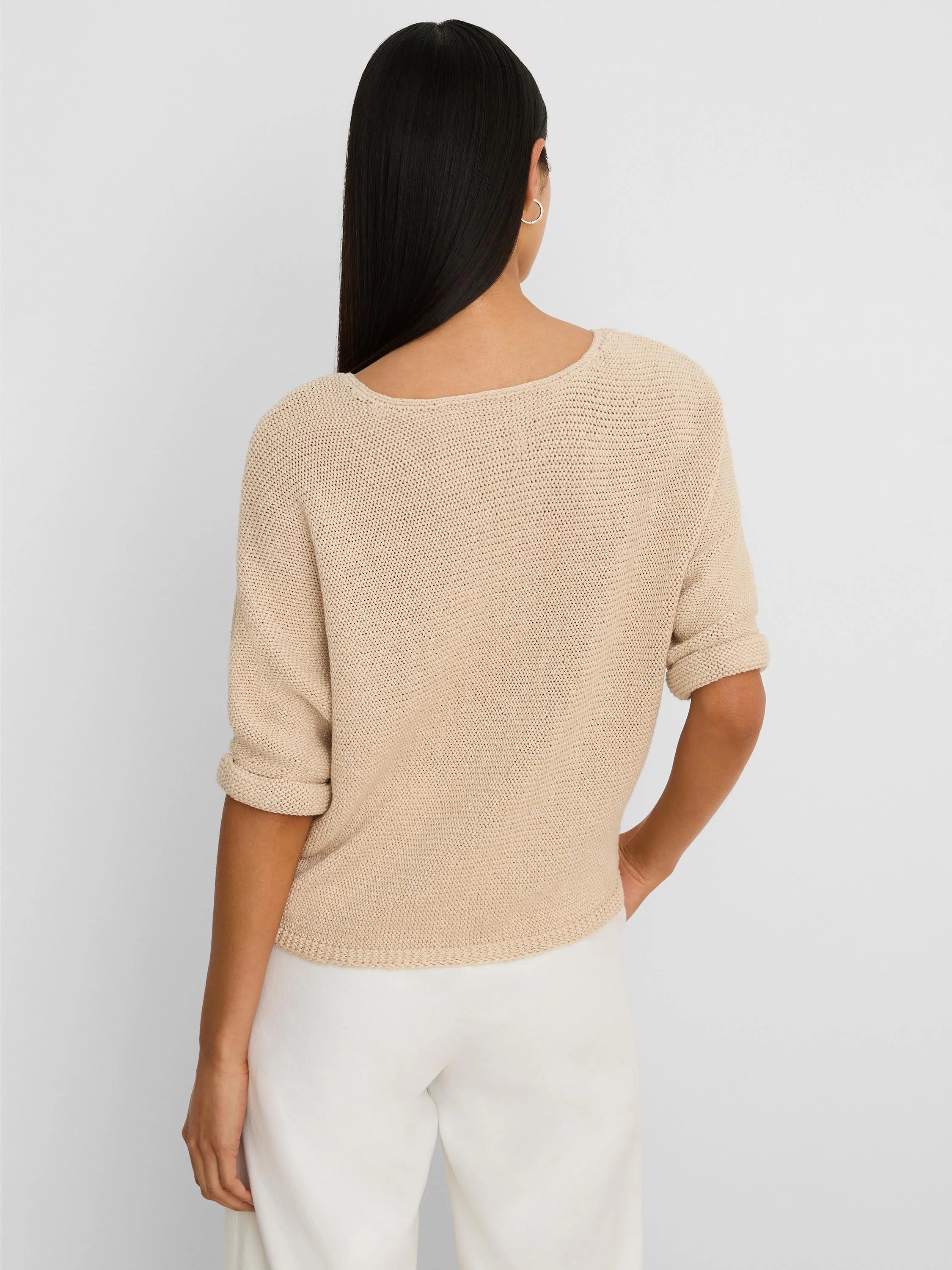 Light beige crimpy cord knit sweater with rolled 3/4 sleeves and wide back neckline. Relaxed fit.