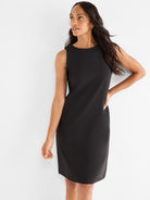 Black sleeveless sheath dress with a crew neck, offering a tailored fit and a knee-length hem for a classic professional look.