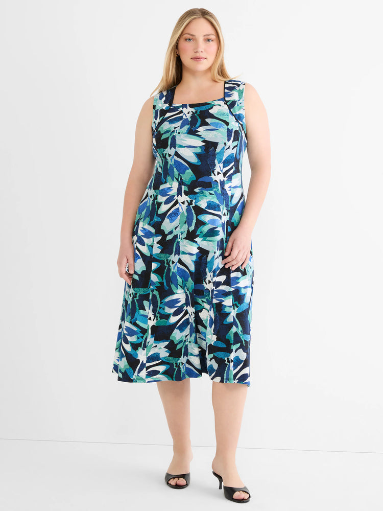 Sleeveless midi dress with square neck and blue, teal, white abstract leaf pattern on a dark background.