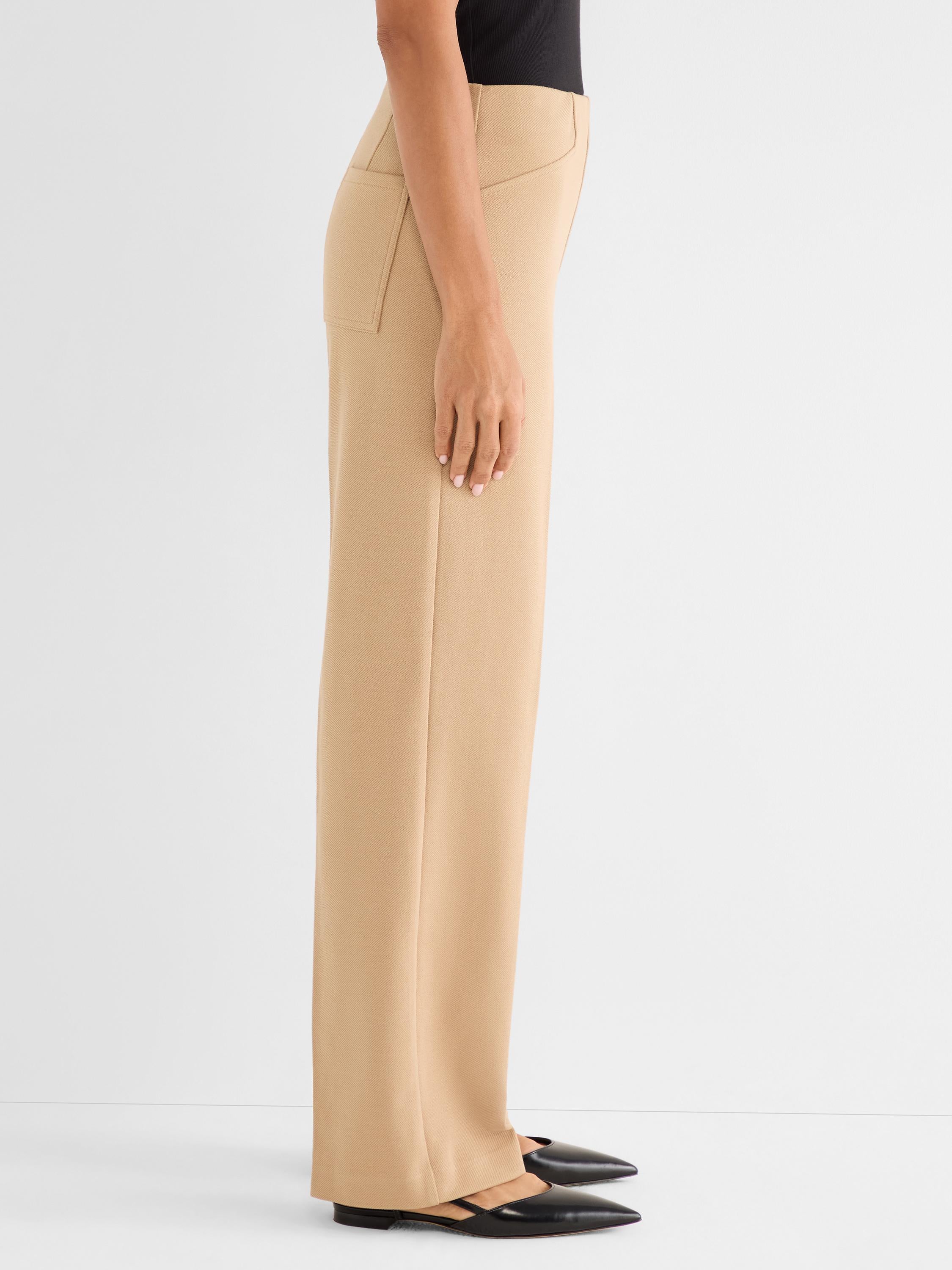 Tan high-waisted pants with a wide straight leg feature structural stitched seams and front slash pockets.