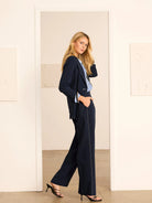 Navy wide-leg pants with white accent stitching, worn by a model.