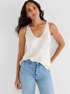 Cream scoop neck tank top with a slight sheen.