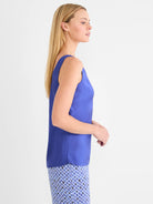 Vibrant blue glossy woven scoop tank on model, side view.