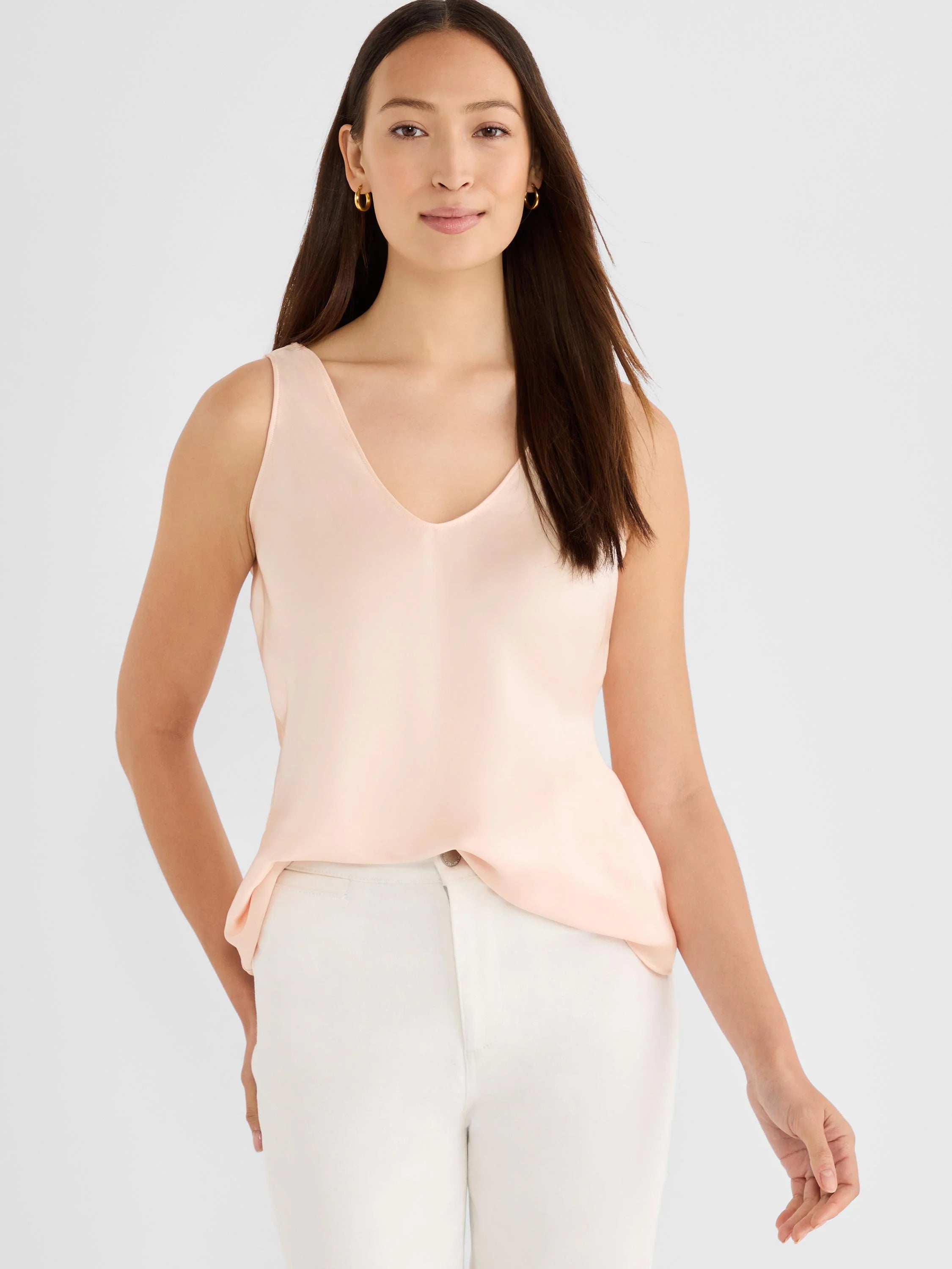 Pale peach woven tank with a V-neck, subtle sheen, and relaxed fit.