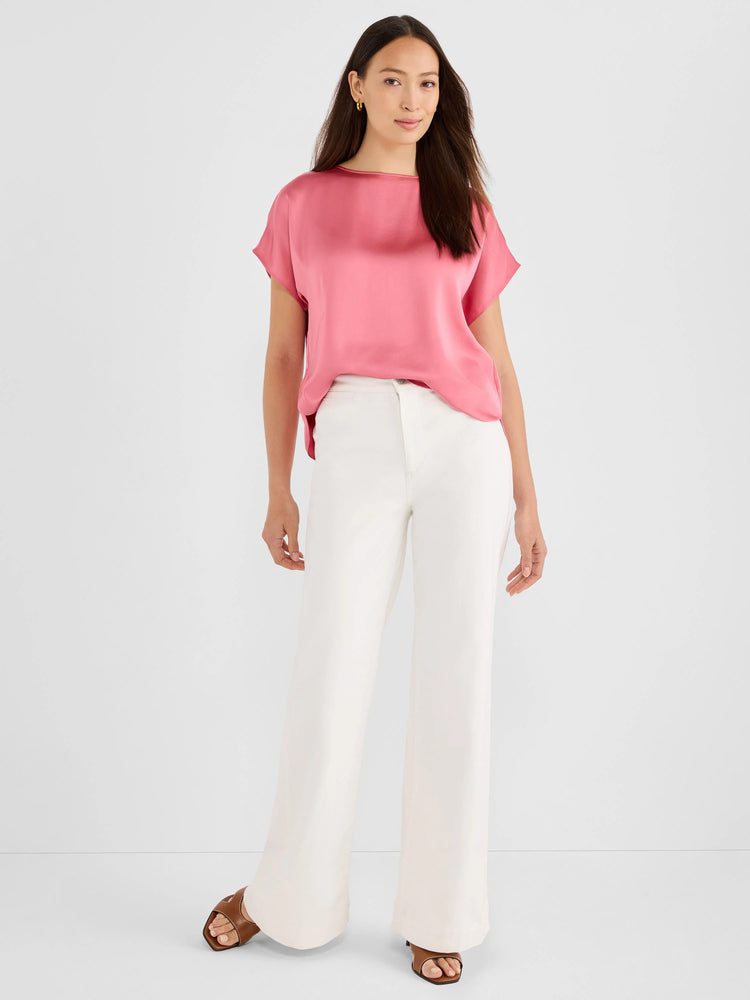 Glossy pink woven tee with boat neck and short sleeves, worn by a model.