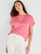 Pink woven tee with a glossy finish, boat neck, and short, wide sleeves.