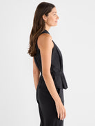 Black sleeveless blouse with a high neckline and a drawstring peplum waist for a relaxed yet defined fit.