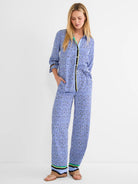 Blue mosaic print shirt and matching wide-leg pants with black, yellow, green, and tan striped trim.