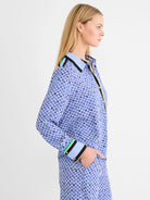 Mosaic patterned blue shirt with squares in blue, black, yellow, white. Collar, placket, cuffs feature black, green,...