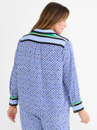 Blue mosaic pattern shirt with small diamonds in blue, black, white, gold. Striped trim in light blue, black, yellow, green.