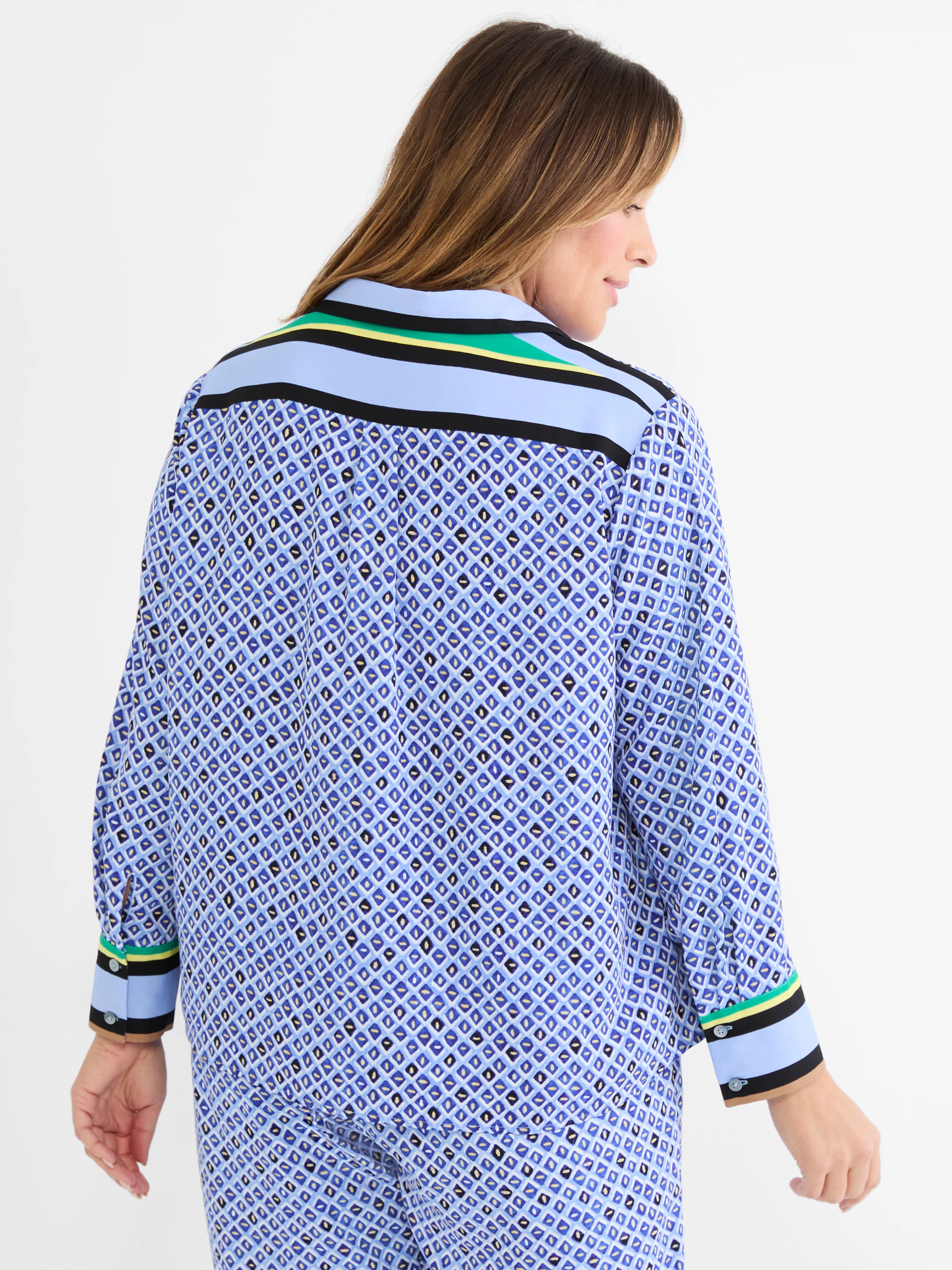 Blue mosaic pattern shirt with small diamonds in blue, black, white, gold. Striped trim in light blue, black, yellow, green.