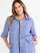 Blue mosaic print shirt with blue, white, black, gold diamonds. Black, light blue, lime green trim; 3/4 cuffed sleeves.