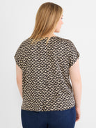 Flowing black and tan geo print blouse has short cap sleeves and a generous, comfortable fit.