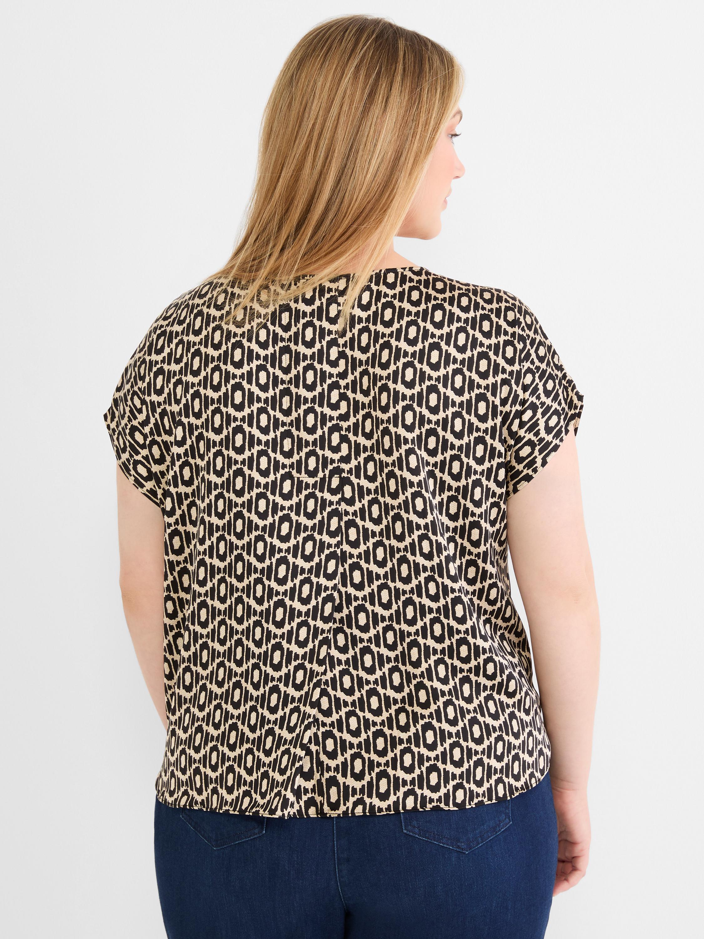 Flowing black and tan geo print blouse has short cap sleeves and a generous, comfortable fit.
