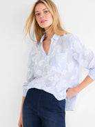Sky blue and white striped top with white floral jacquard pattern, V-neck, and rolled long sleeves.