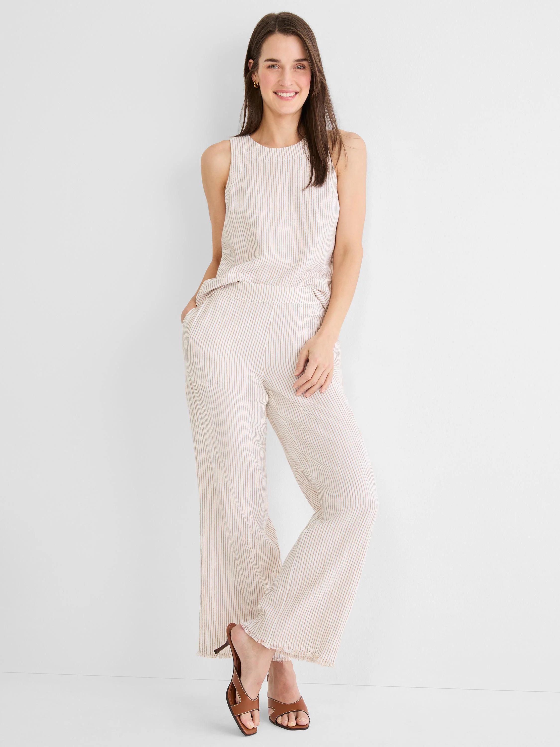 Light beige sleeveless tank with thin brown vertical stripes and a rounded neck.