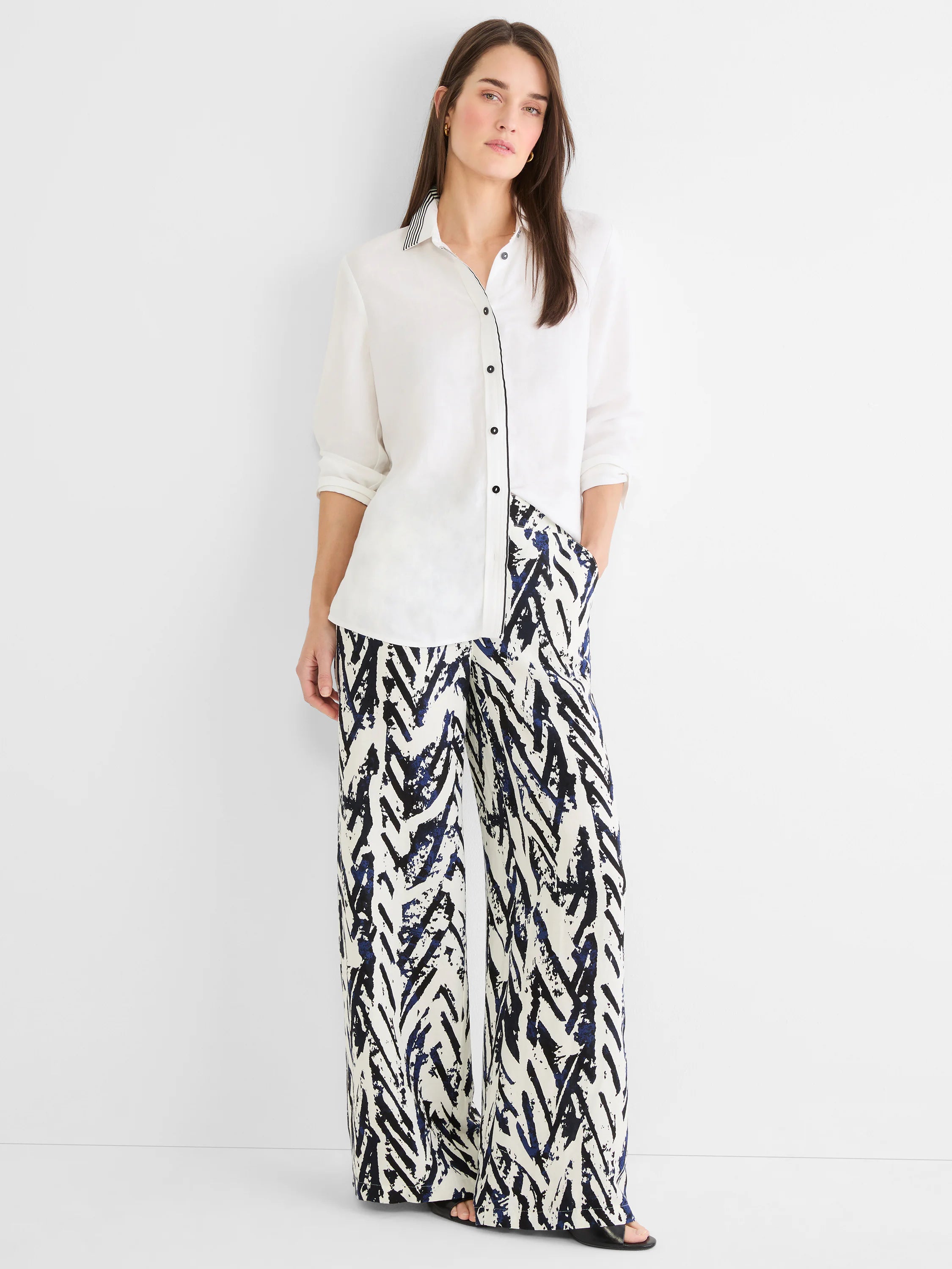 Off-white linen shirt with black & white striped inner collar, black piping on the placket, and black buttons.
