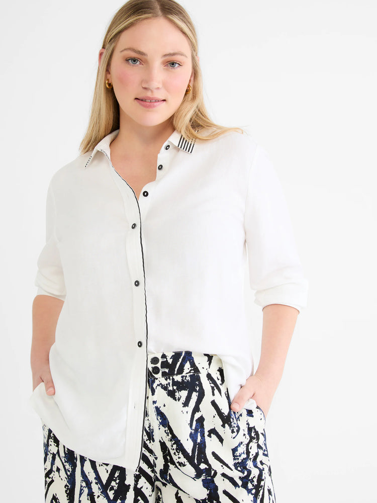 White linen shirt with black & white striped collar trim, black piping on placket, and black buttons.