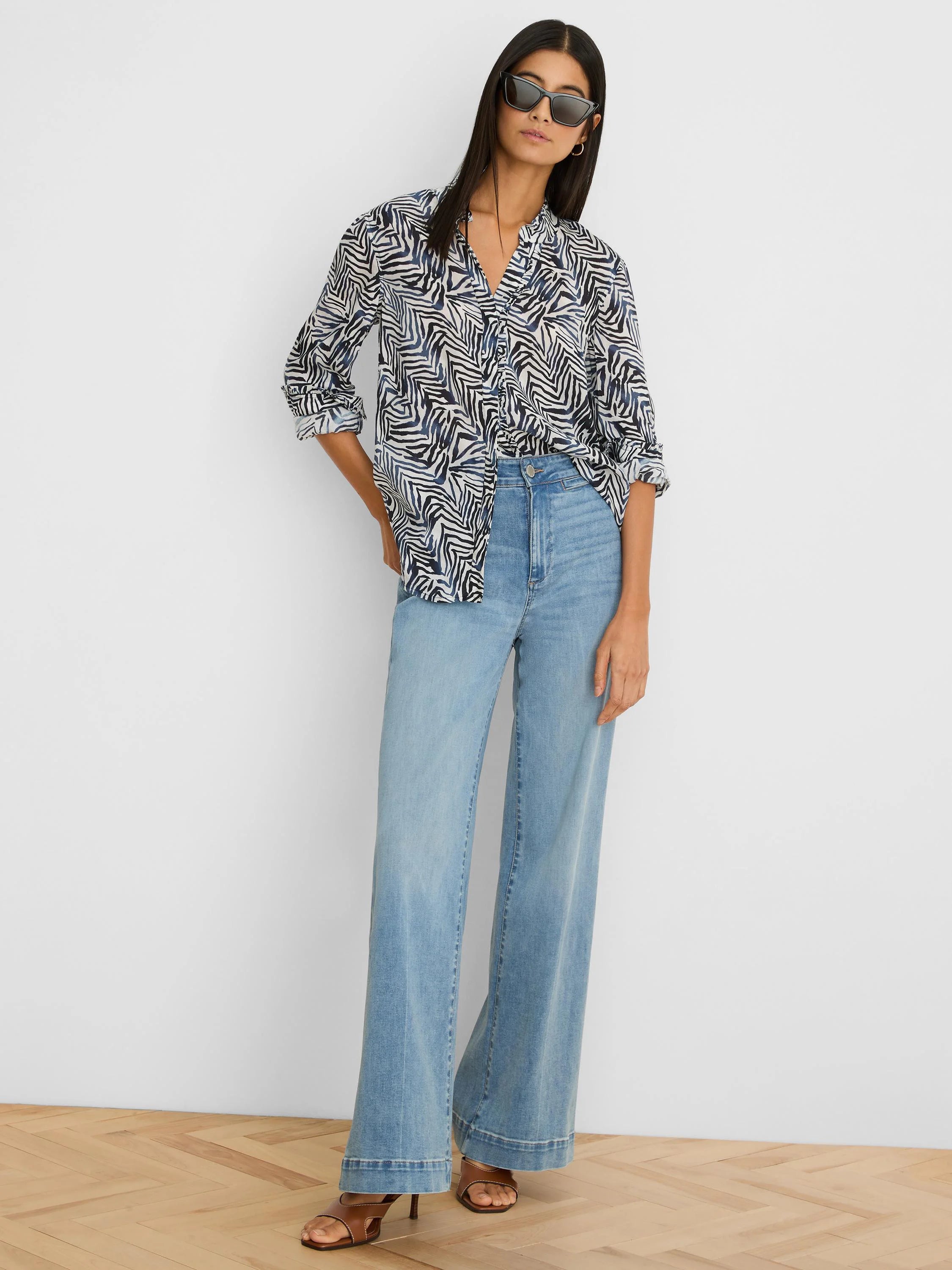 White collared V-neck shirt with irregular dark blue & black zig-zag pattern. Sleeves rolled.