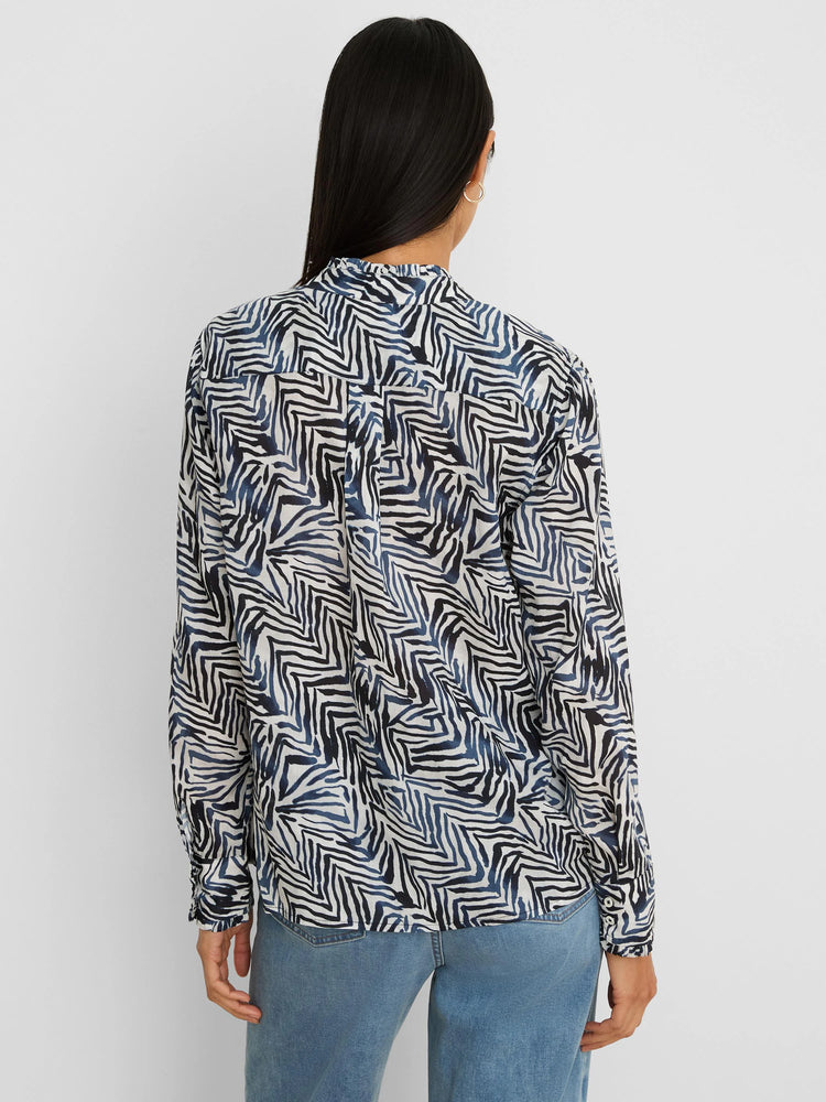 Long-sleeved shirt with a white base featuring an abstract pattern of dark blue and black jagged lines.