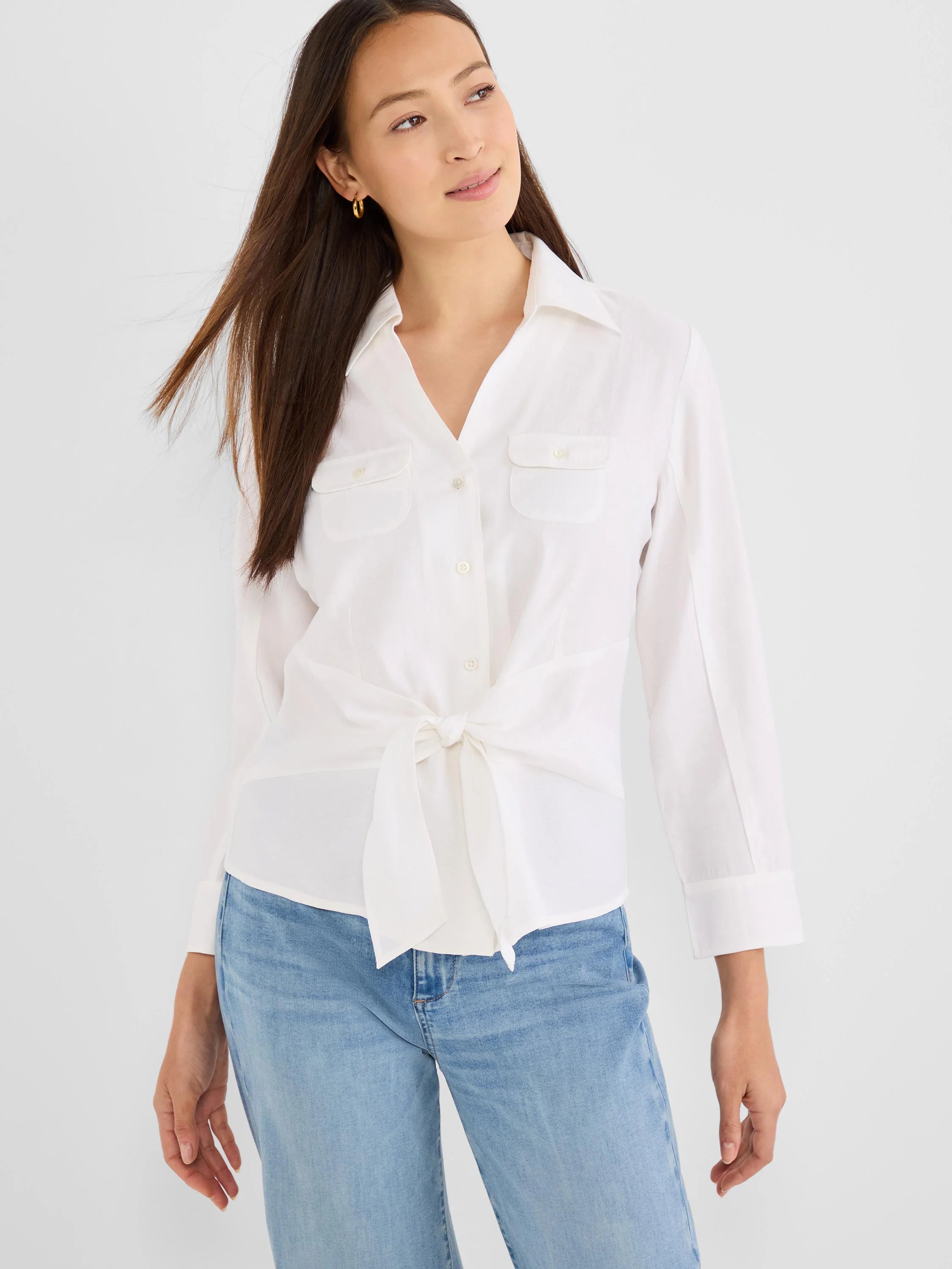 White button-up shirt with two flap chest pockets, long sleeves with cuffs, and a tie-front knot at the waist.