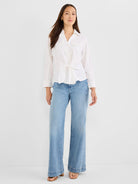 White button-down shirt with a tie-front, chest pockets, and cuffed sleeves.