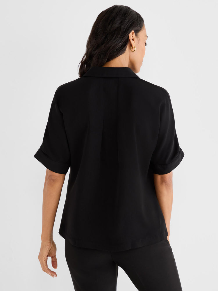 Black relaxed short-sleeved collared blouse features back pleating and folded cuffs.