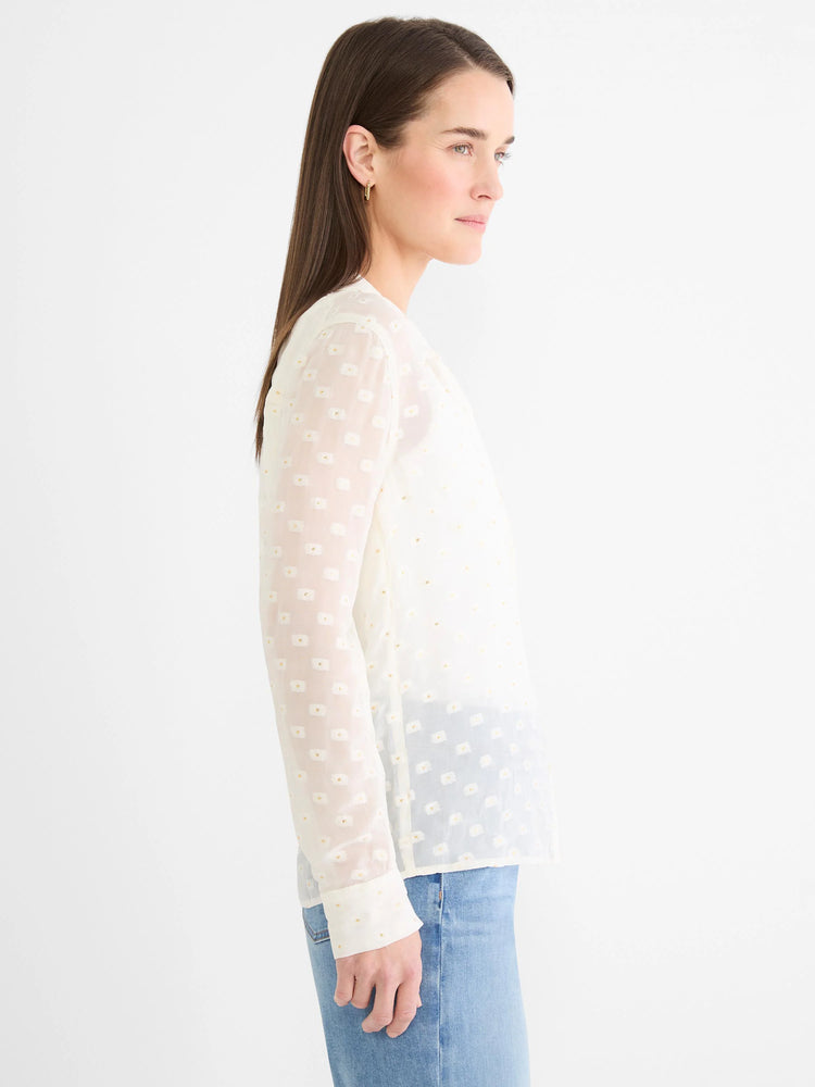 Off-white semi-sheer long-sleeve shirt with subtle gold dot pattern.