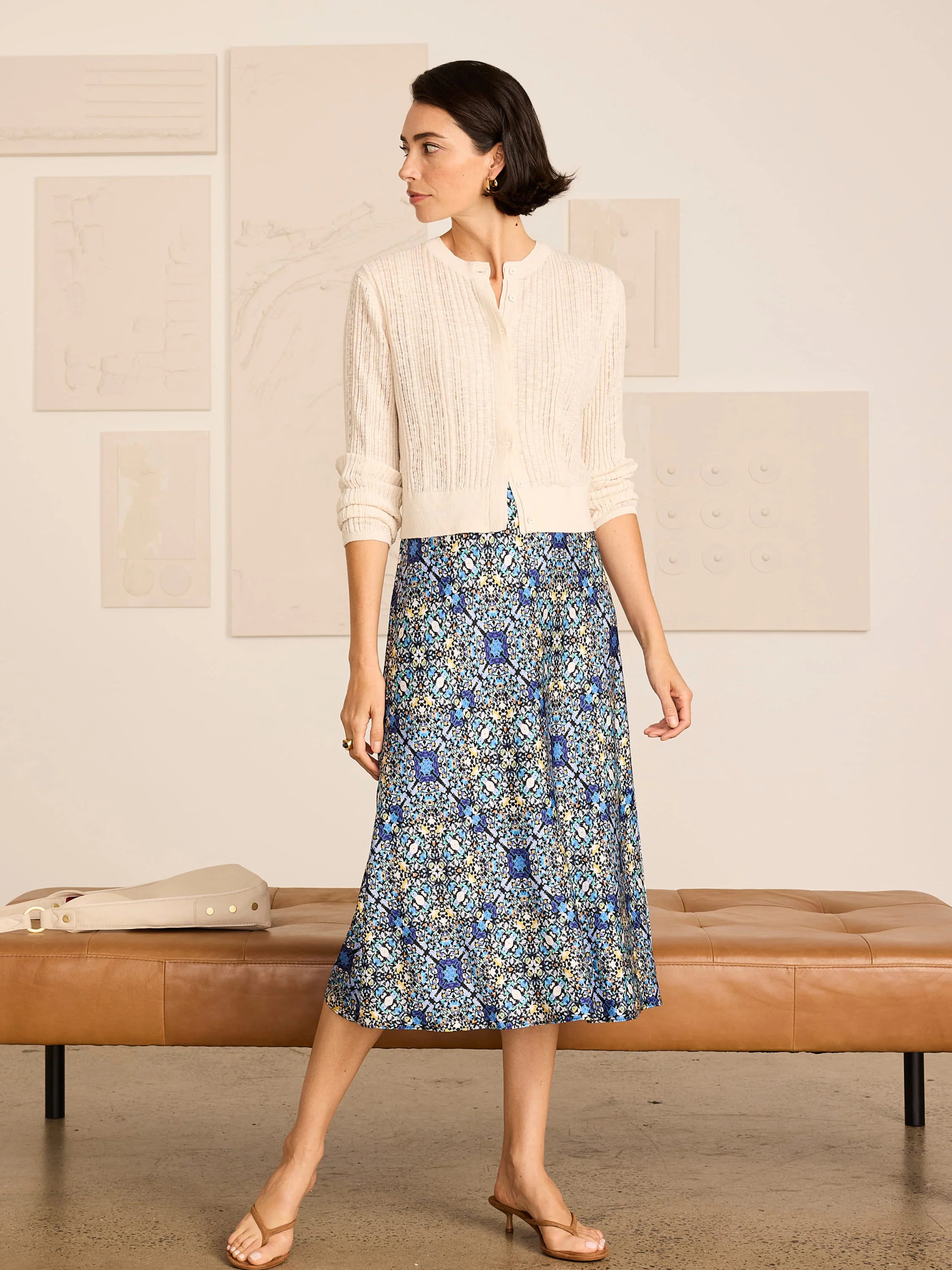 Midi slip skirt with an intricate blue, teal, and gold filigree tile pattern on a dark background.
