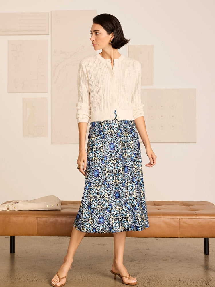 Midi slip skirt with an intricate blue, teal, and gold filigree tile pattern on a dark background.