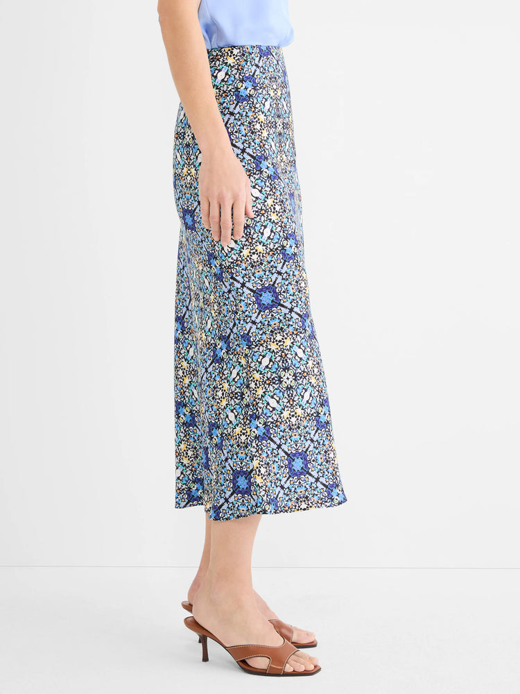 Midi slip skirt featuring a detailed filigree tile pattern in blues, teal, white, and yellow on a black background.