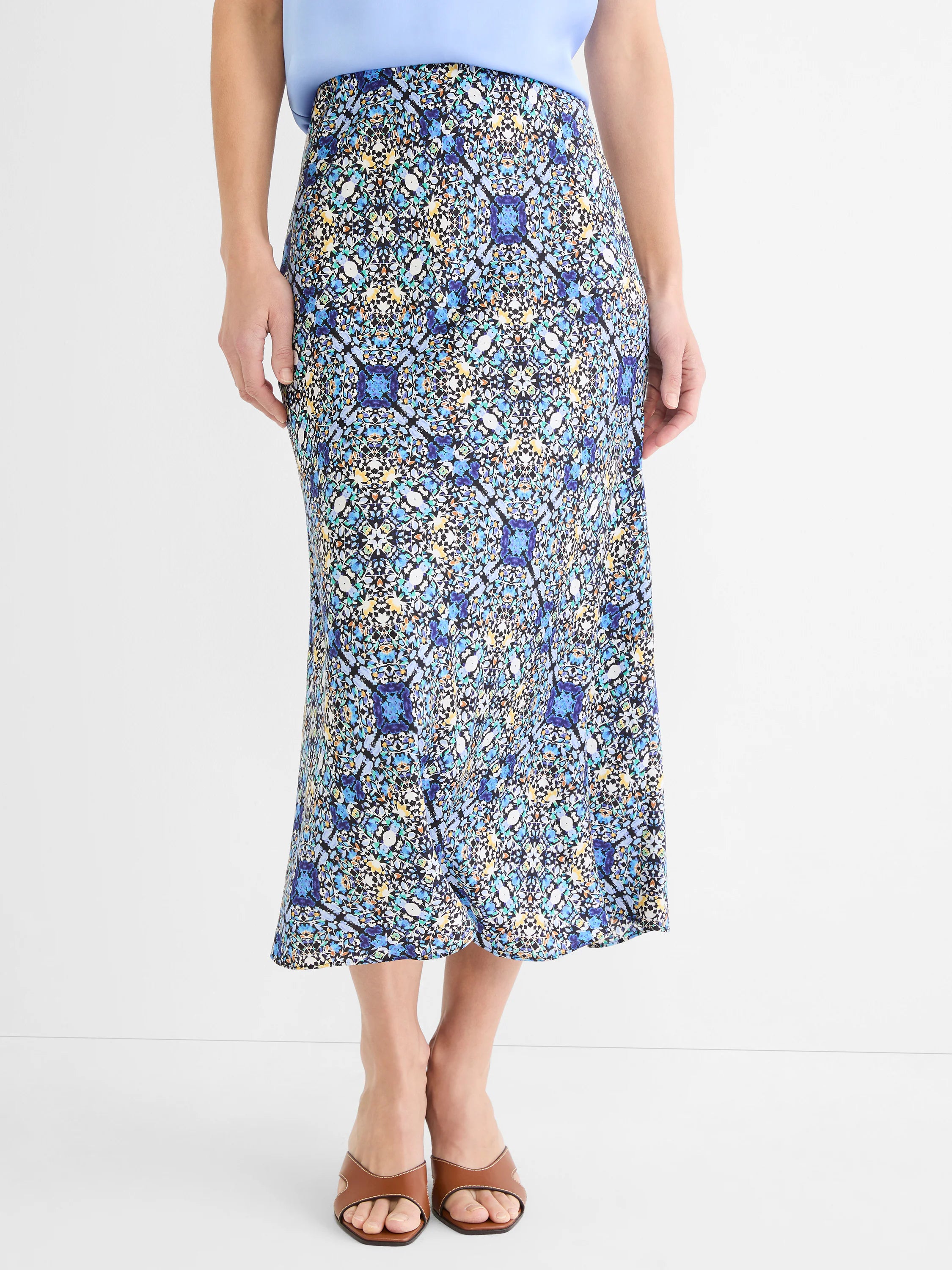 Midi slip skirt with intricate blue, yellow, teal, and white filigree tile pattern on black.