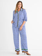Wide-leg pants with blue, black, white mosaic pattern. Striped cuffs in light blue, black, tan, green, yellow.