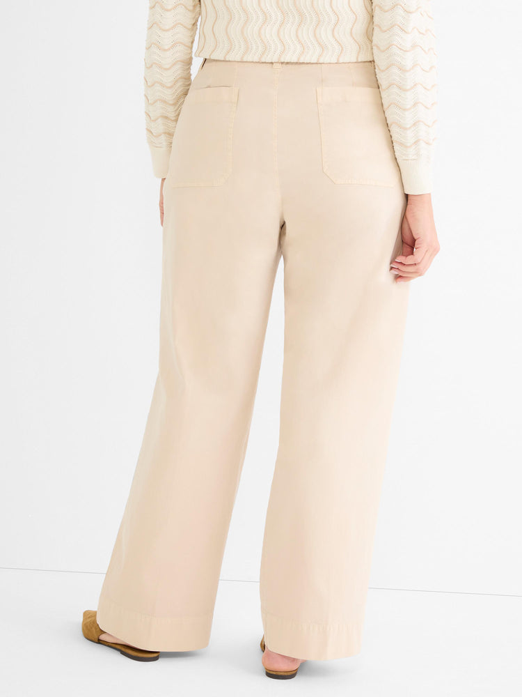 Relaxed fit beige wide-leg trousers are detailed from the back, showing a high waist and simple flat pockets.