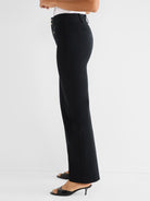 Slim-fit black tailored trousers featuring a high waist, visible side gold buttons, and a straight leg opening.