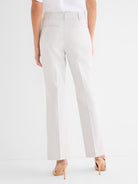Pale beige tailored trousers feature a high rise, straight fit, and rear welt pockets.