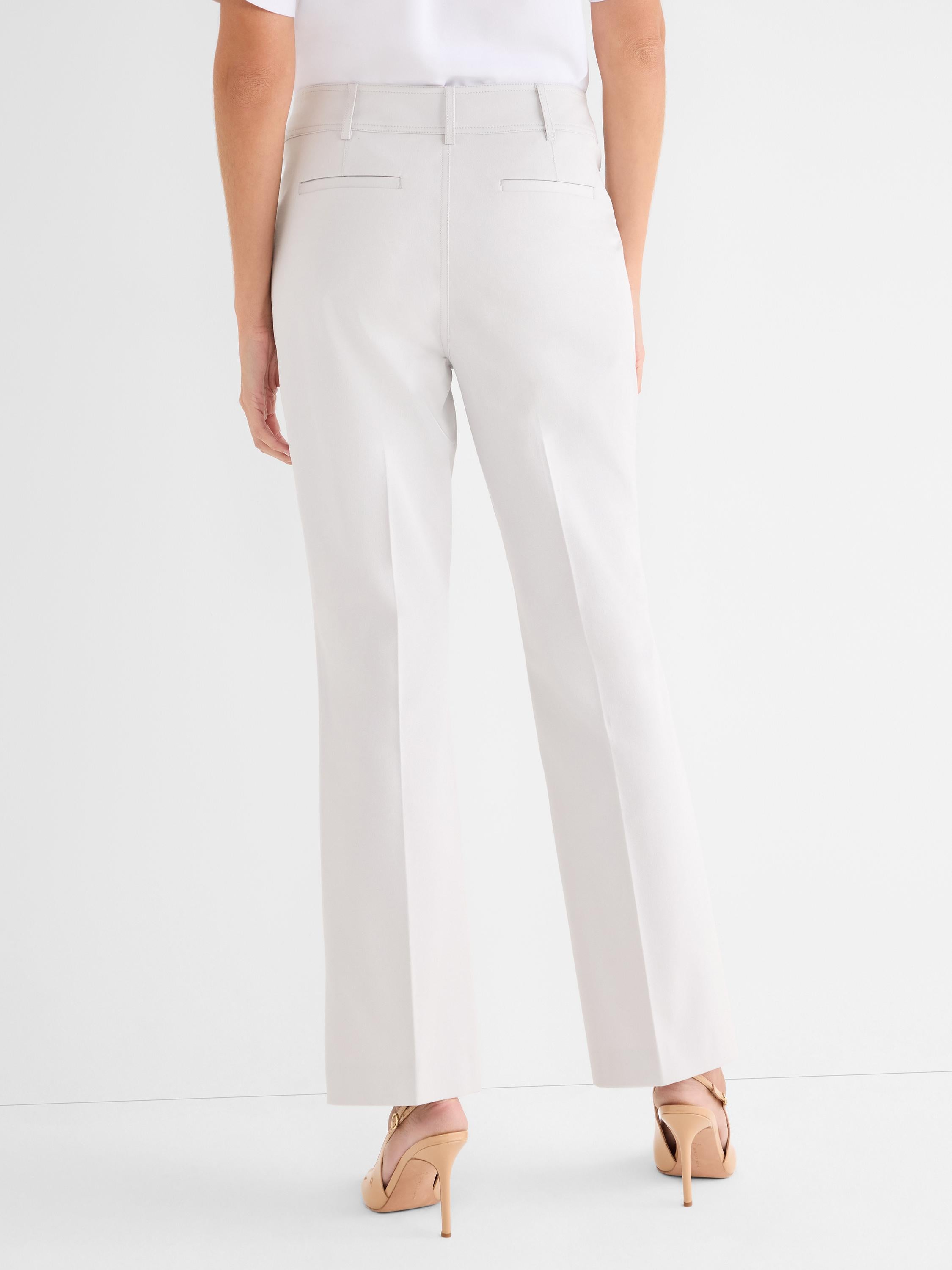 Pale beige tailored trousers feature a high rise, straight fit, and rear welt pockets.