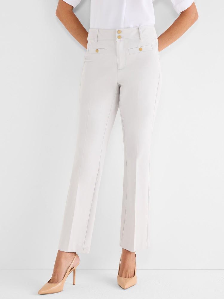 Light beige straight trousers are worn, detailed with a high waist, center creases, and four gold decorative buttons.