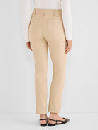 Slim-fit khaki trousers featuring back patch pockets and a prominent vertical seam detail down the center back leg.