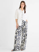 Wide-leg pant featuring an off-white background with an abstract indigo blue and black crosshatch pattern.