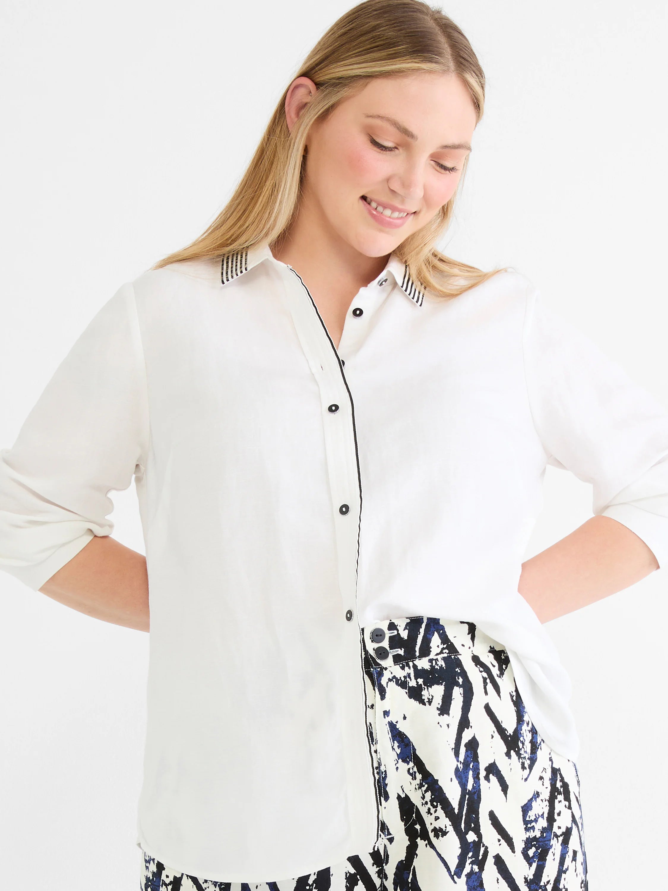 Pants with white fabric and dark blue abstract crosshatch pattern.