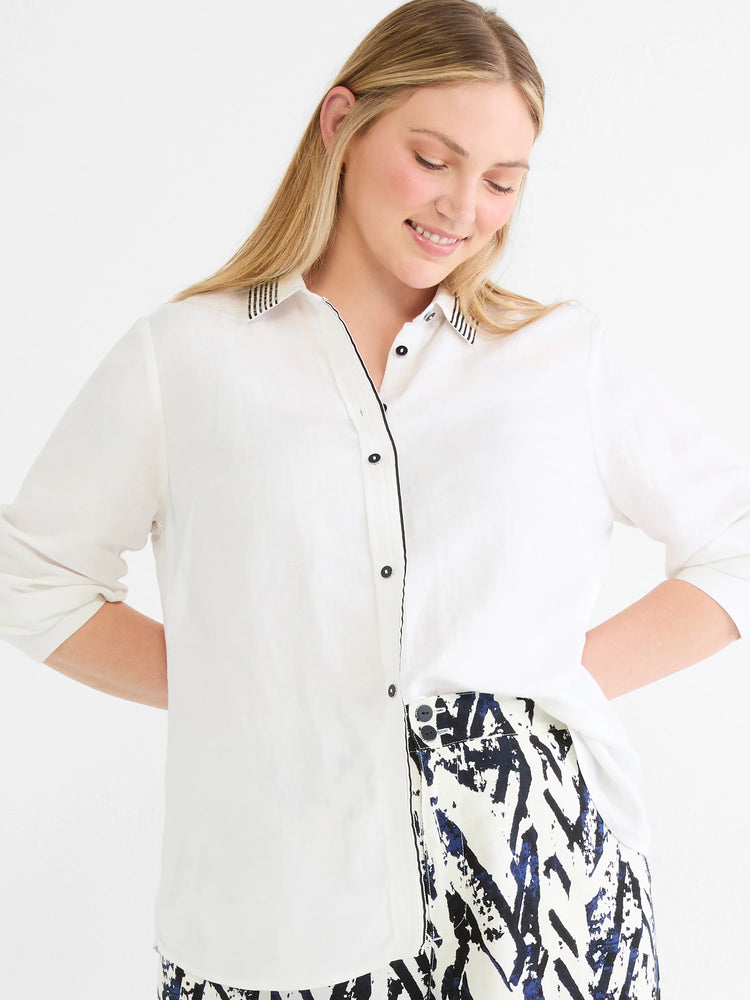 Pants with white fabric and dark blue abstract crosshatch pattern.